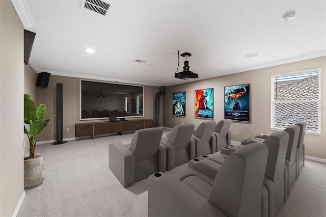 home theater with baseboards, visible vents, crown molding, and light carpet