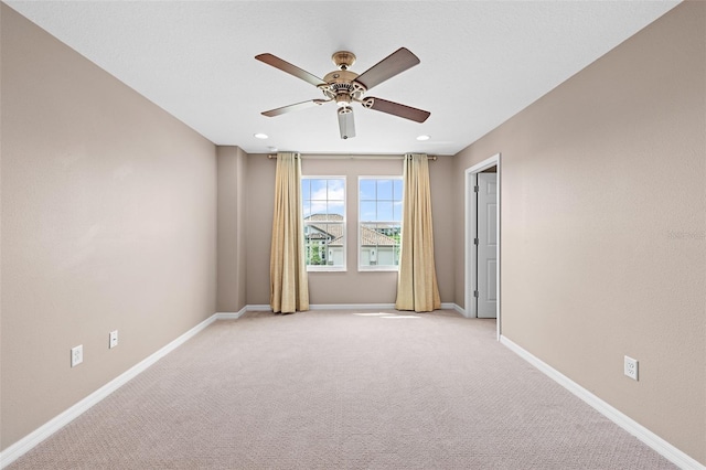 empty room with light carpet, baseboards, ceiling fan, and recessed lighting