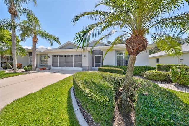 ranch-style home featuring a garage and a front yard