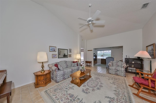 living room with light tile patterned floors, a textured ceiling, high vaulted ceiling, and ceiling fan