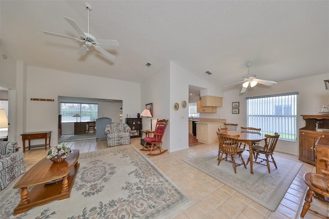 living room featuring light tile patterned floors, ceiling fan, and vaulted ceiling