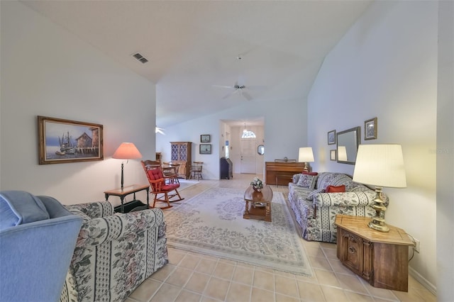 living room featuring ceiling fan, vaulted ceiling, and light tile patterned floors