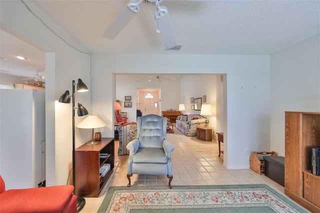 interior space featuring a textured ceiling and ceiling fan