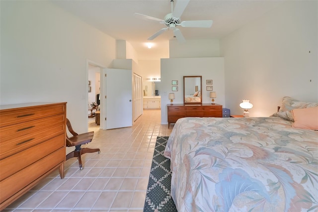 tiled bedroom with ensuite bath and ceiling fan