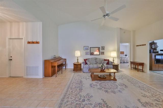 living room featuring light tile patterned floors, high vaulted ceiling, and ceiling fan