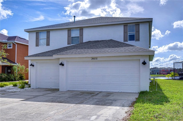 view of front facade with a garage and a front lawn