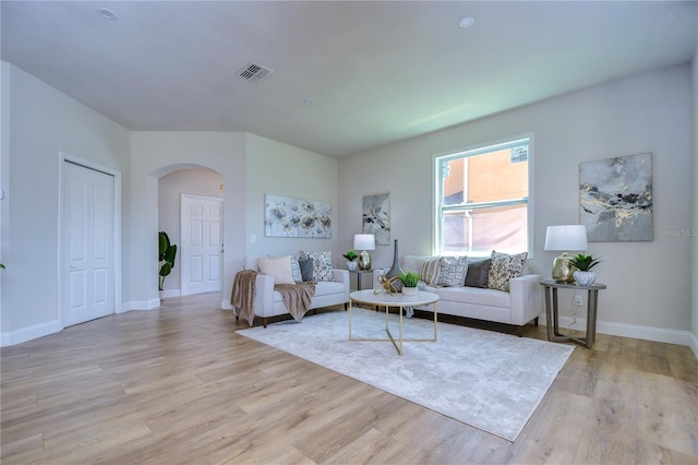 20131 Nob Oak Ave, Tampa, FL 33647 - living room featuring arched walkways, light wood-style flooring, and baseboards