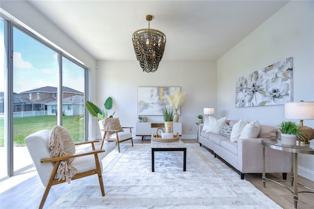 living room with a chandelier and light hardwood / wood-style floors