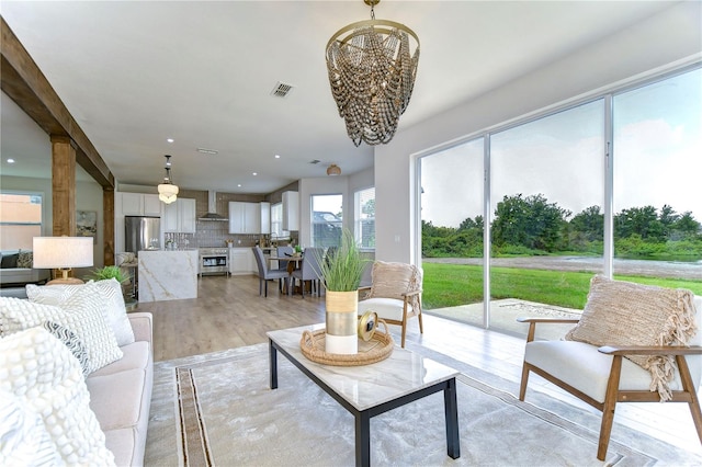 living room with light hardwood / wood-style flooring and a chandelier