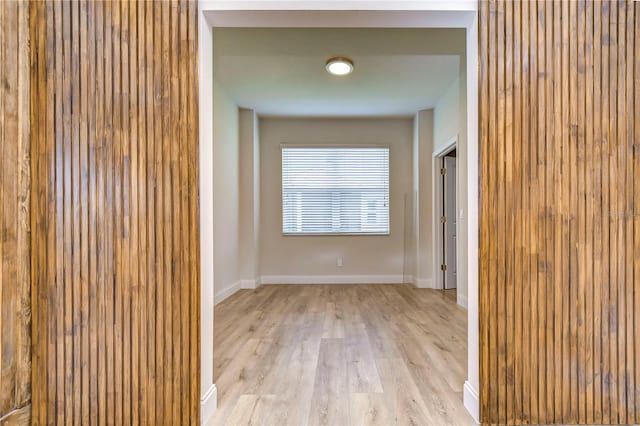 corridor with light hardwood / wood-style floors