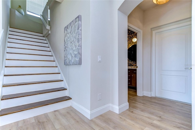 20131 Nob Oak Ave, Tampa, FL 33647 - stairs with wood finished floors, arched walkways, and baseboards