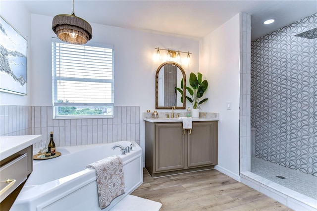 bathroom featuring vanity, hardwood / wood-style flooring, and shower with separate bathtub