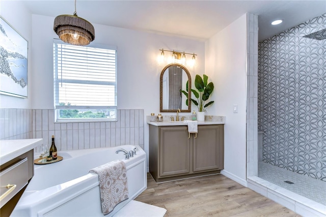 20131 Nob Oak Ave, Tampa, FL 33647 - full bath featuring vanity, a garden tub, a tile shower, wood finished floors, and tile walls