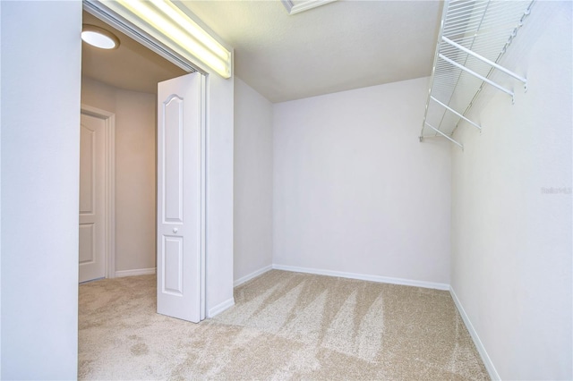 spacious closet with light colored carpet