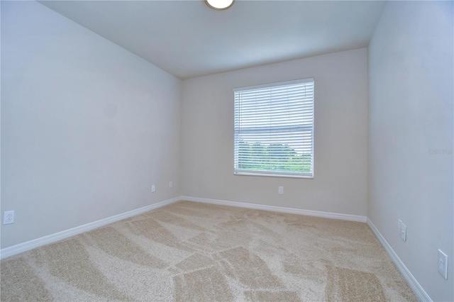 unfurnished room with light carpet