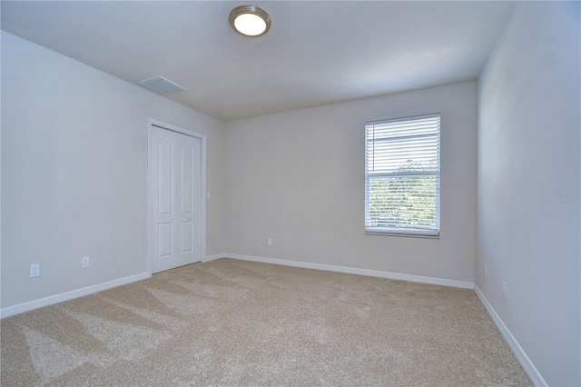 unfurnished room with light carpet