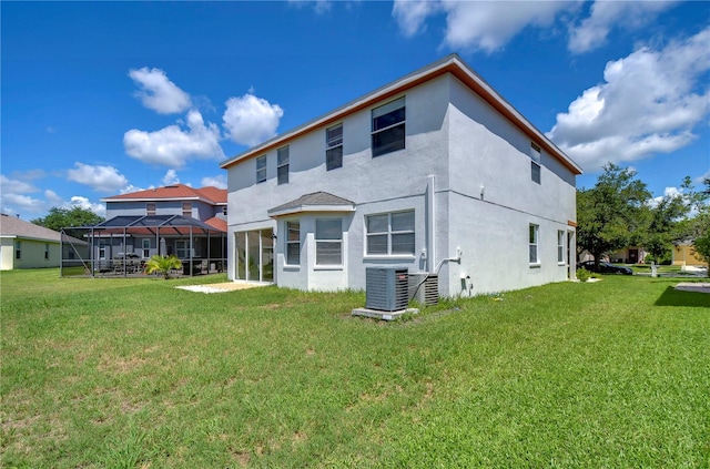 rear view of house featuring central AC unit, a lawn, and glass enclosure