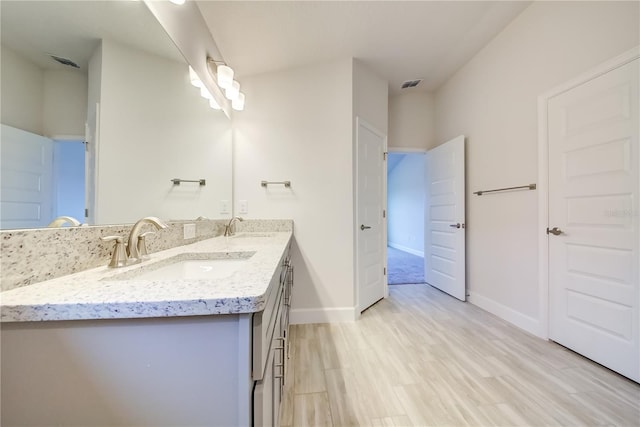 bathroom with hardwood / wood-style floors and vanity