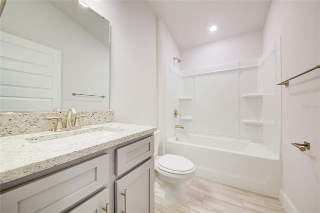 full bathroom featuring wood-type flooring, vanity, shower / bath combination, and toilet