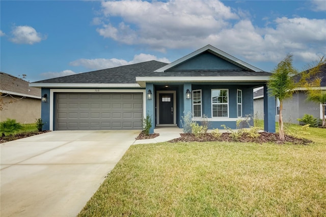 view of front of home featuring a front yard and a garage