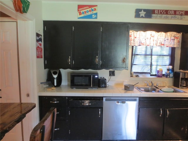 kitchen with sink, stainless steel dishwasher, and tile counters