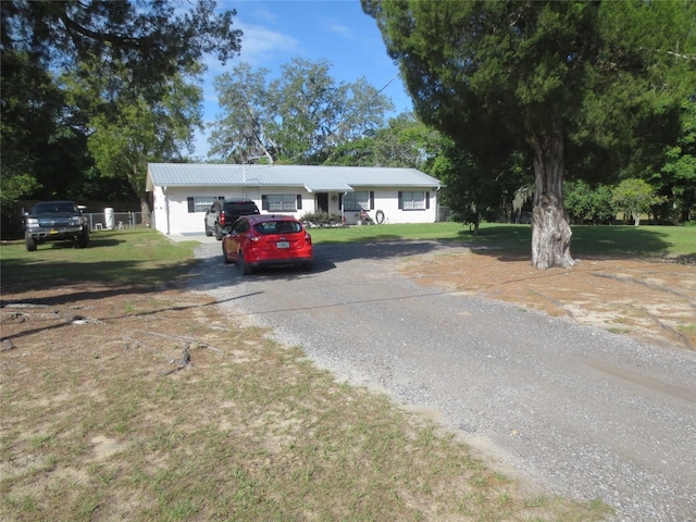 ranch-style house with a garage and a front yard