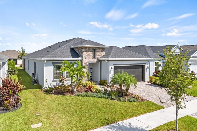 view of front of property featuring a garage and a front yard