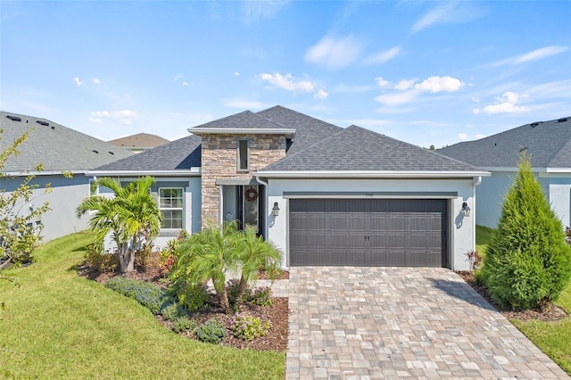 view of front of property featuring a garage and a front yard