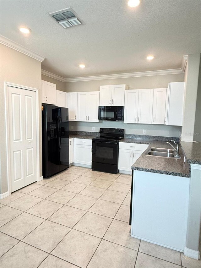 kitchen featuring sink, black appliances, and white cabinets