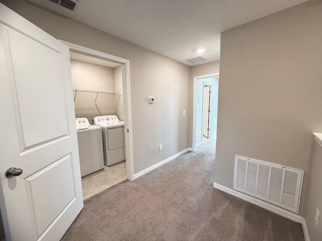 laundry area with light carpet and washing machine and dryer