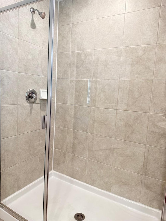 bathroom with a shower with door