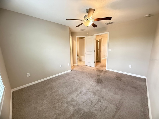 unfurnished bedroom featuring connected bathroom, ceiling fan, and carpet