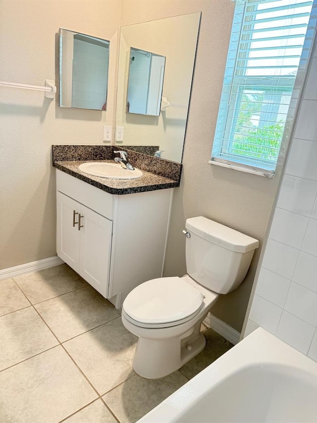 bathroom with vanity, toilet, a bathtub, and tile patterned flooring