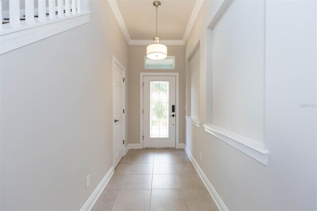 doorway with light tile patterned flooring and crown molding