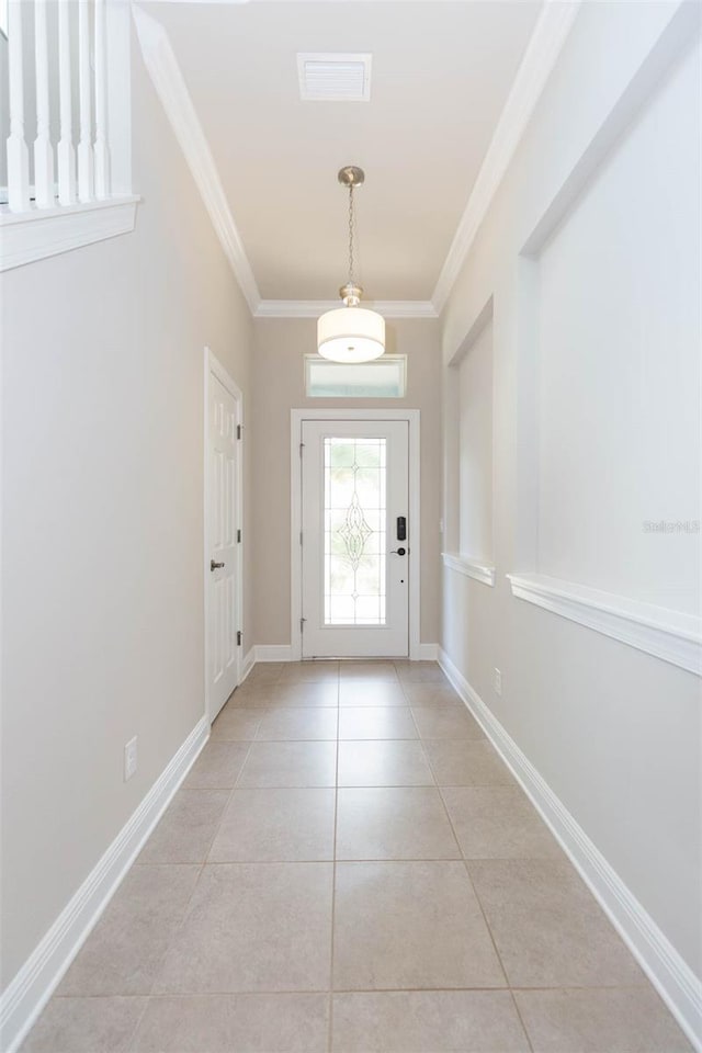 tiled foyer entrance with crown molding