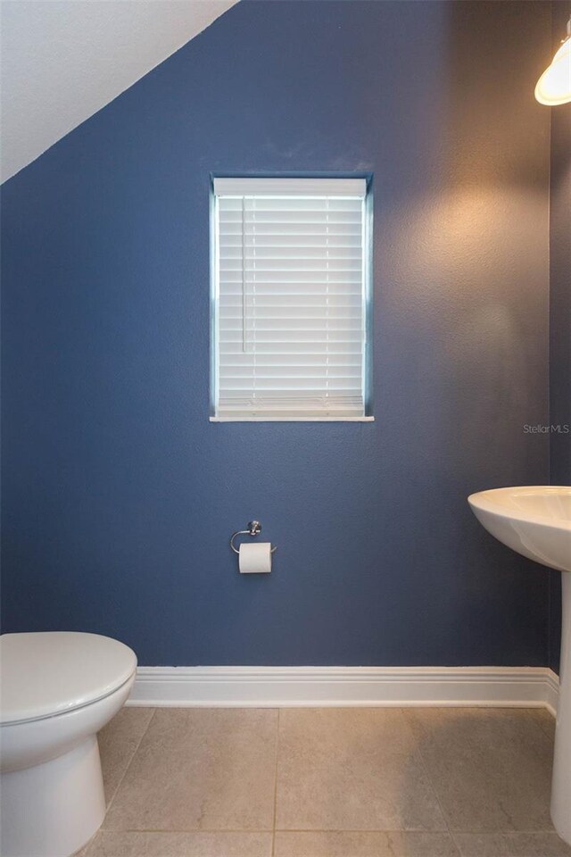 bathroom with tile patterned flooring and toilet