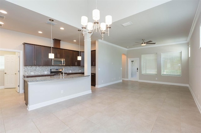 kitchen with tasteful backsplash, light tile patterned floors, ceiling fan with notable chandelier, light stone countertops, and decorative light fixtures