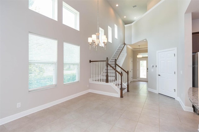 interior space featuring light tile patterned floors, plenty of natural light, and a high ceiling