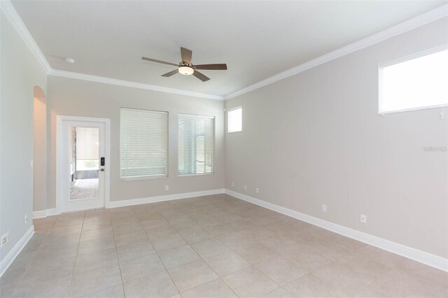 tiled spare room with ceiling fan and ornamental molding