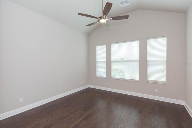 unfurnished room with lofted ceiling, ceiling fan, and dark wood-type flooring