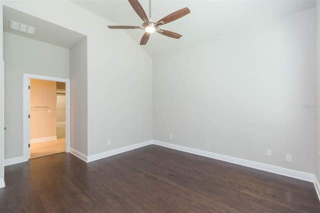 unfurnished room featuring ceiling fan, dark hardwood / wood-style flooring, and a towering ceiling