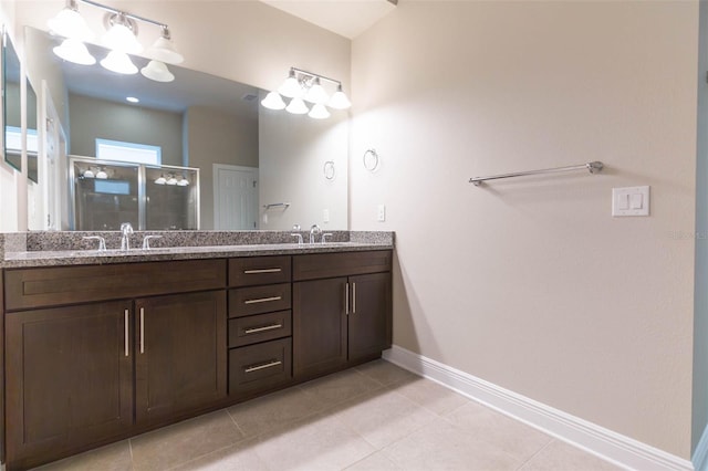 bathroom featuring tile patterned floors, walk in shower, and double vanity