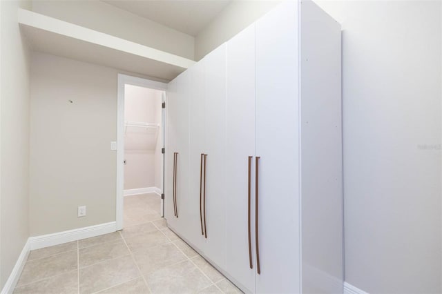 corridor featuring light tile patterned floors