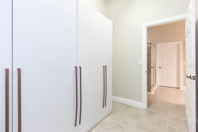 corridor with light tile patterned floors