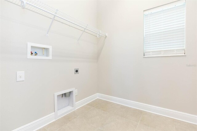 washroom with hookup for a washing machine, electric dryer hookup, and light tile patterned floors