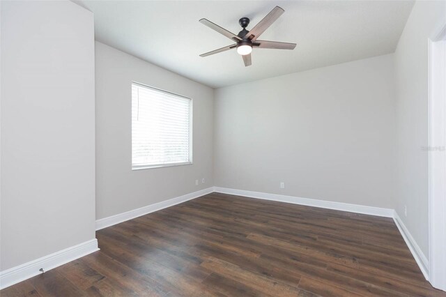 spare room featuring dark hardwood / wood-style flooring and ceiling fan