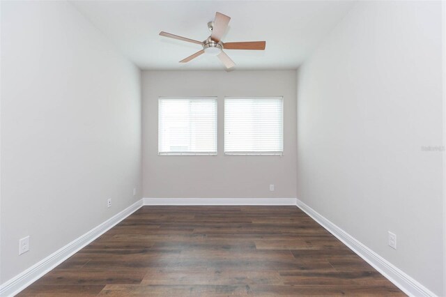 spare room with dark hardwood / wood-style floors and ceiling fan