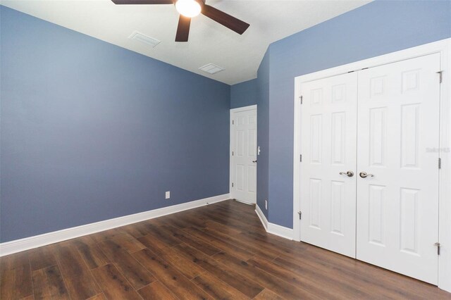 unfurnished bedroom featuring wood-type flooring, a closet, and ceiling fan