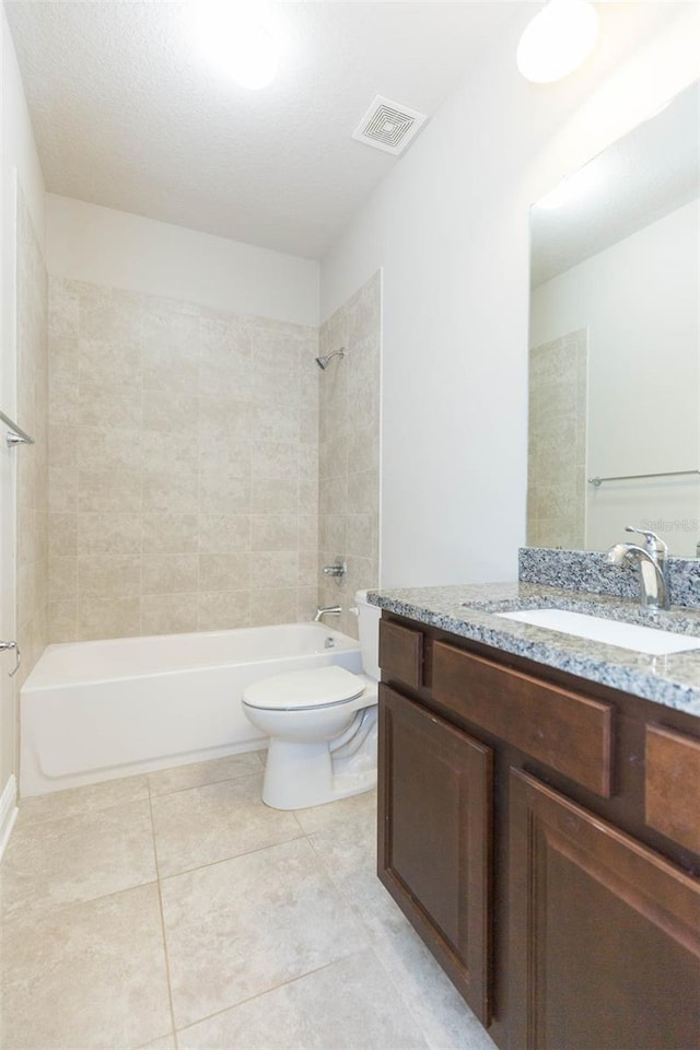 full bathroom with vanity, tiled shower / bath combo, and toilet