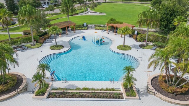 view of pool featuring a patio and a lawn